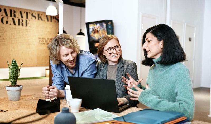 Three colleagues having a meeting in front of a computer